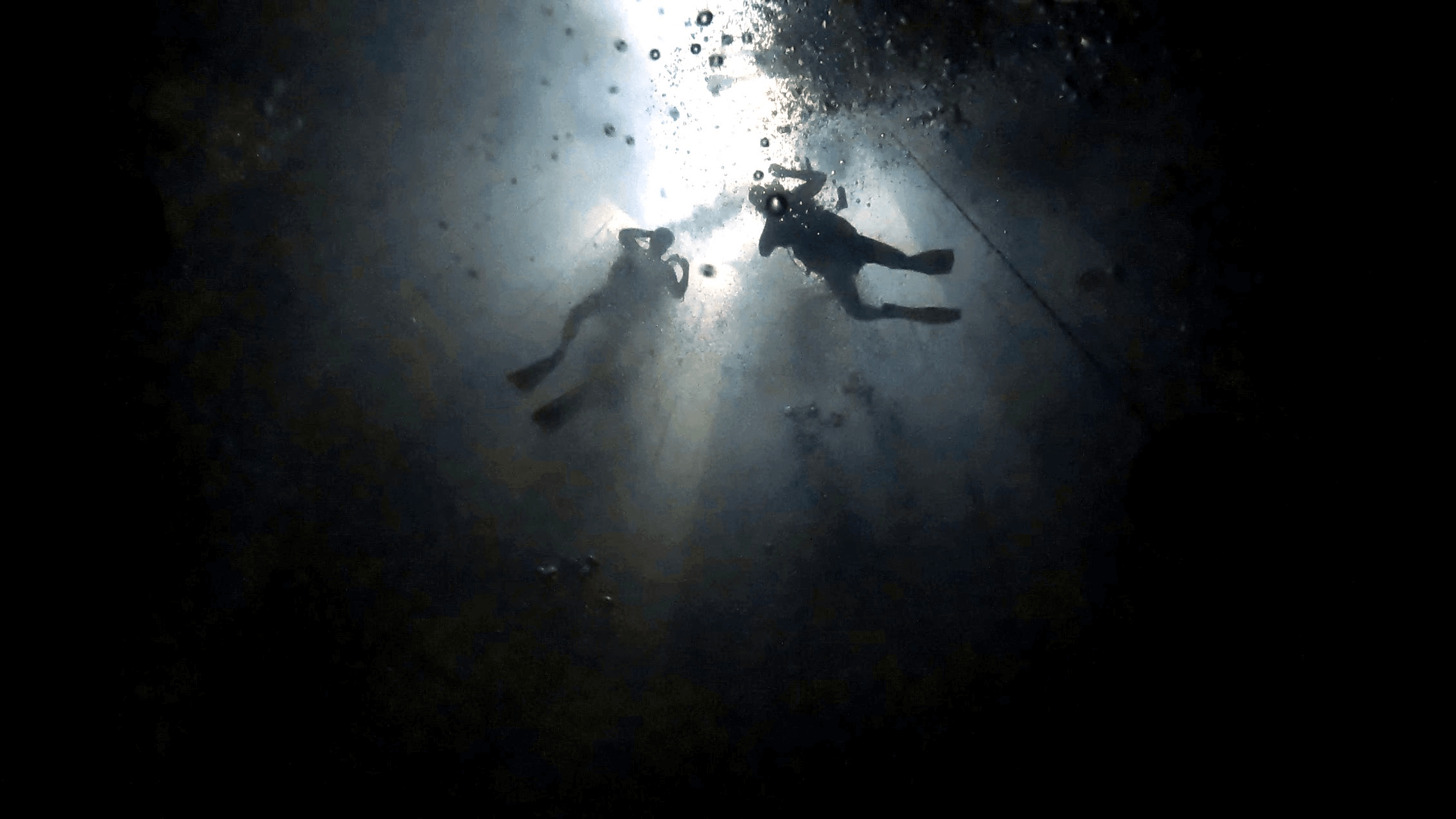 A bottom-up shot from the pool floor, capturing descending divers during our dive at Nemo Brussels